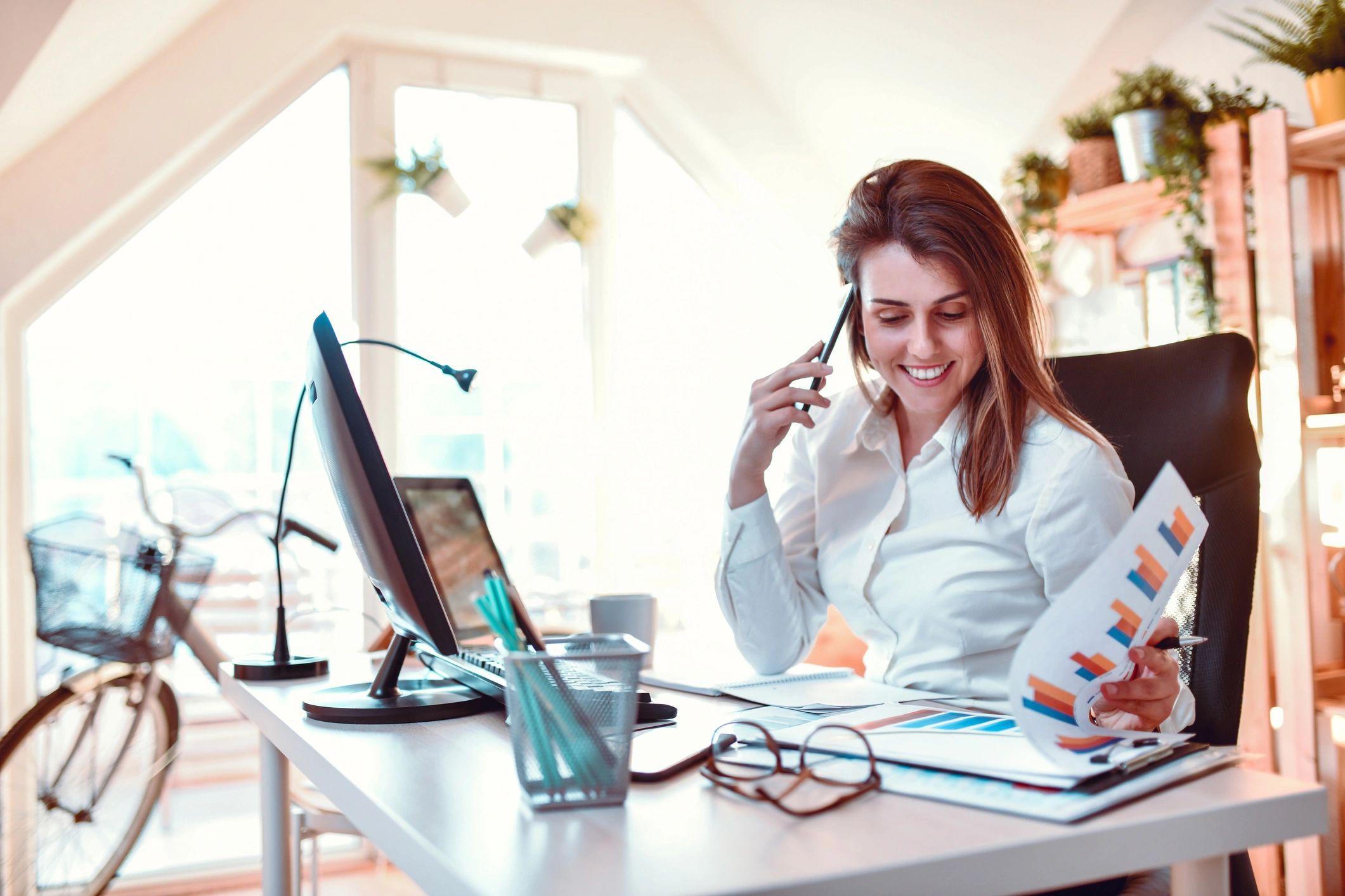Woman reviewing notes while working from home