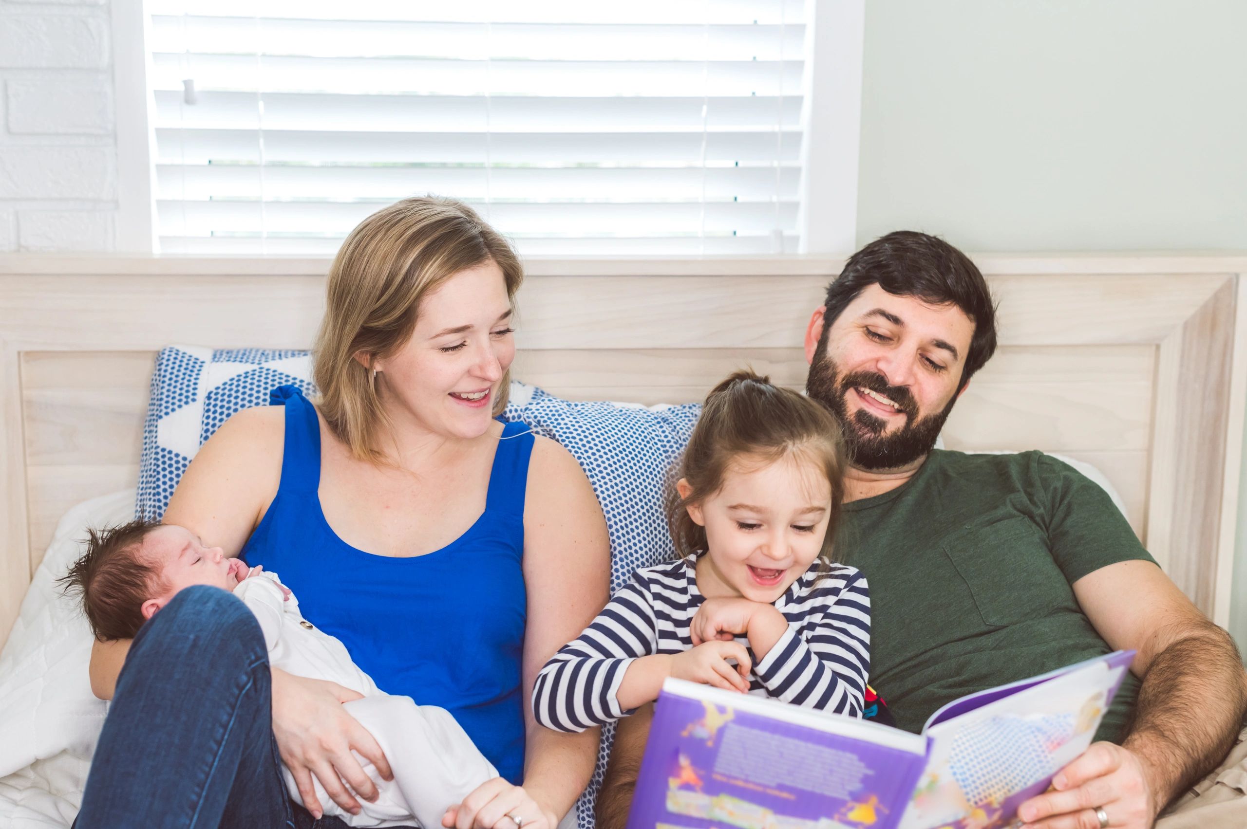 Young family reading together at home
